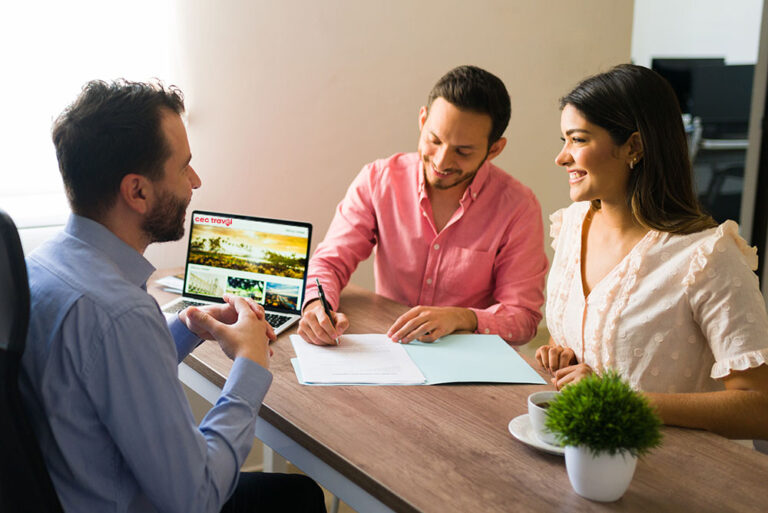 Excited couple discussing their vacation plans at cec travel agency with a cec travel advisor and feeling happy about their upcoming holiday.